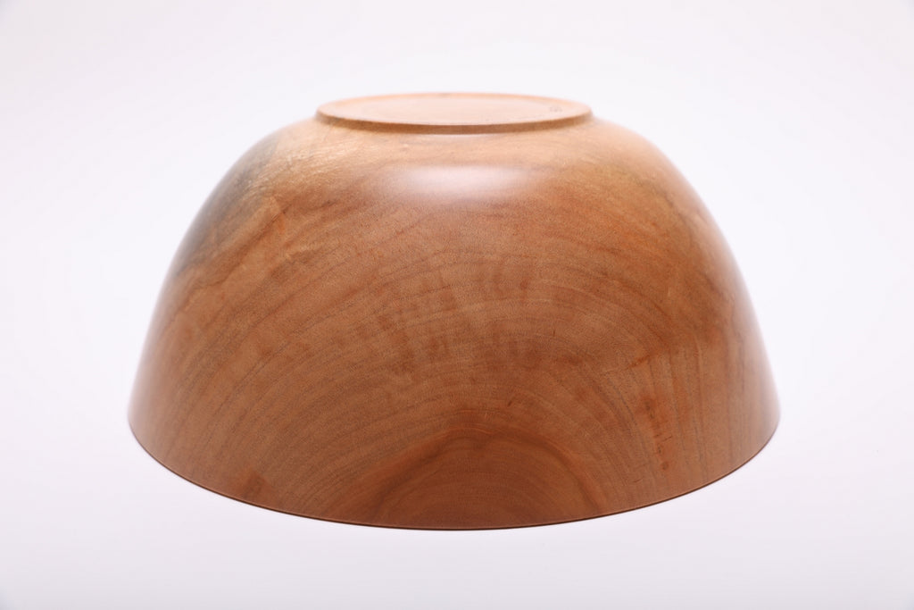 Bottom view of spalted sugar maple wood bowl showing turned raised foot and maker's finish on the base