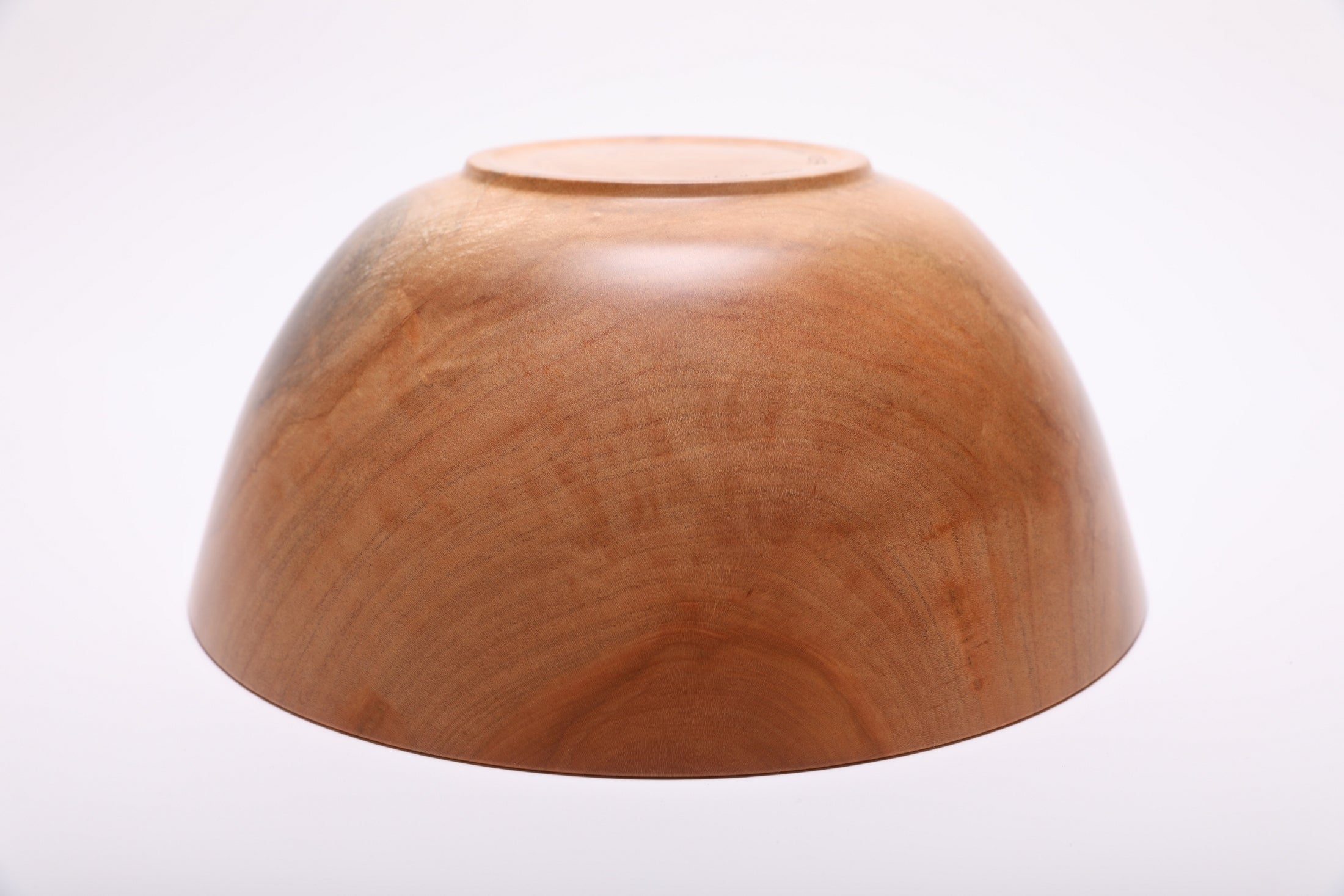 Bottom view of spalted sugar maple wood bowl showing turned raised foot and maker's finish on the base