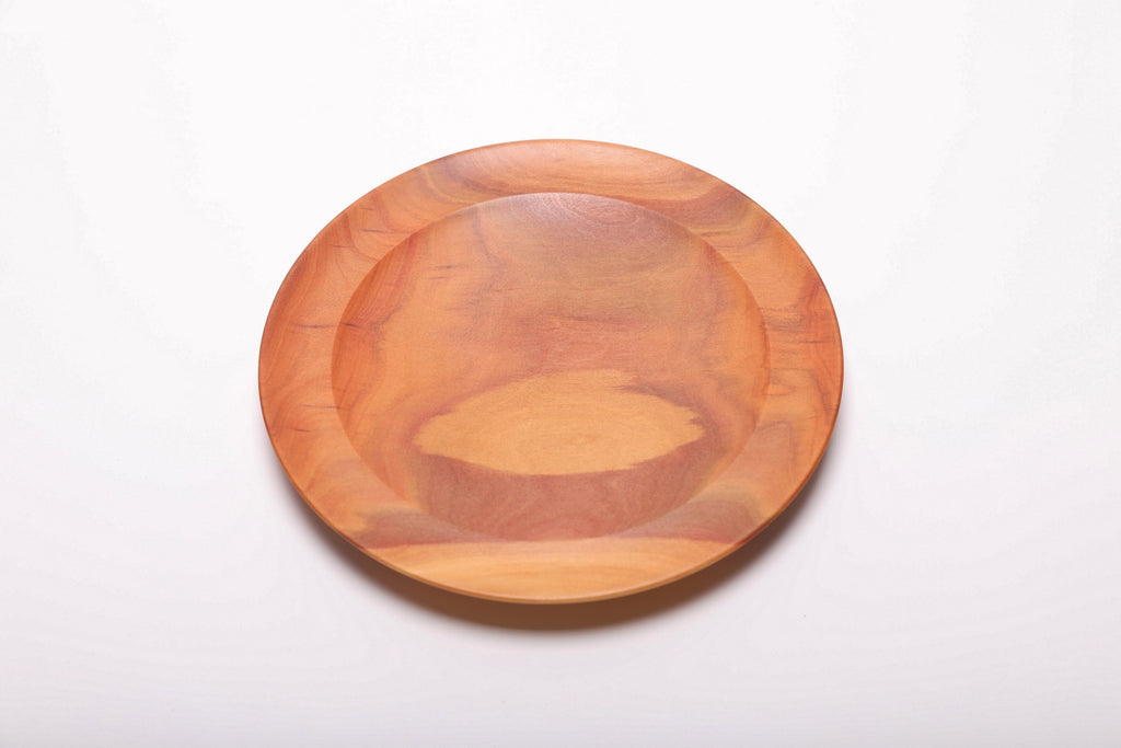 Pink ivory wood ring dish top view showing vibrant pink heartwood grain, hand-turned with food-safe oil finish, 7 1/4 inches diameter