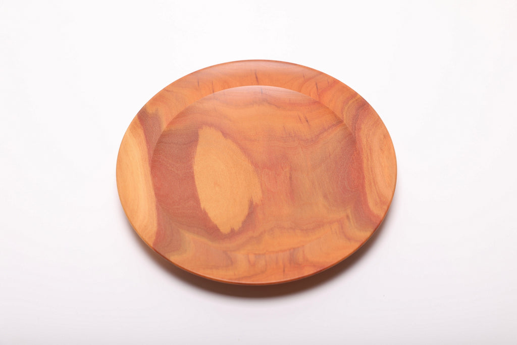 Overhead view of hand-turned pink ivory wood jewelry dish showing natural grain variation and figured heartwood