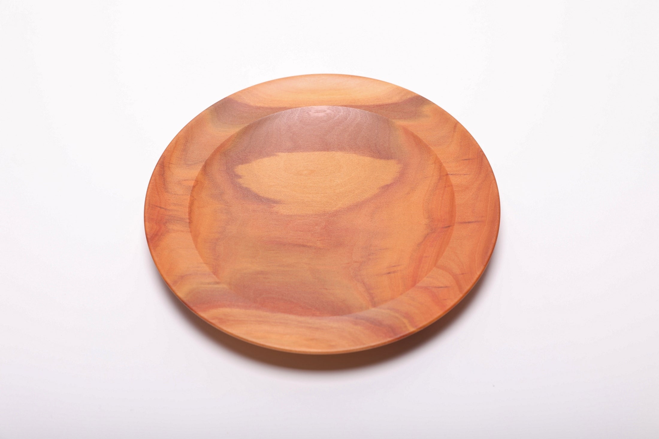 Top view of pink ivory wooden dish showing undercut rim detail and shallow profile, 3/4 inch depth
