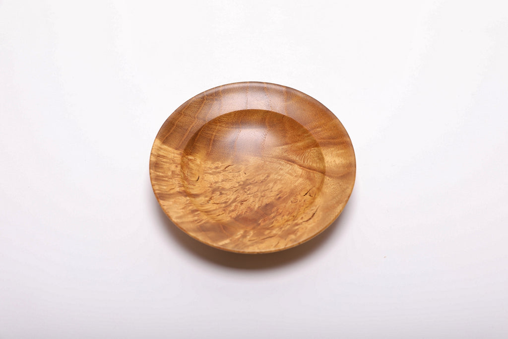 Mulberry burl wood ring dish top view showing golden birdseye figure and burl pattern, hand-turned with food-safe oil finish, 4 5/8 inches diameter

