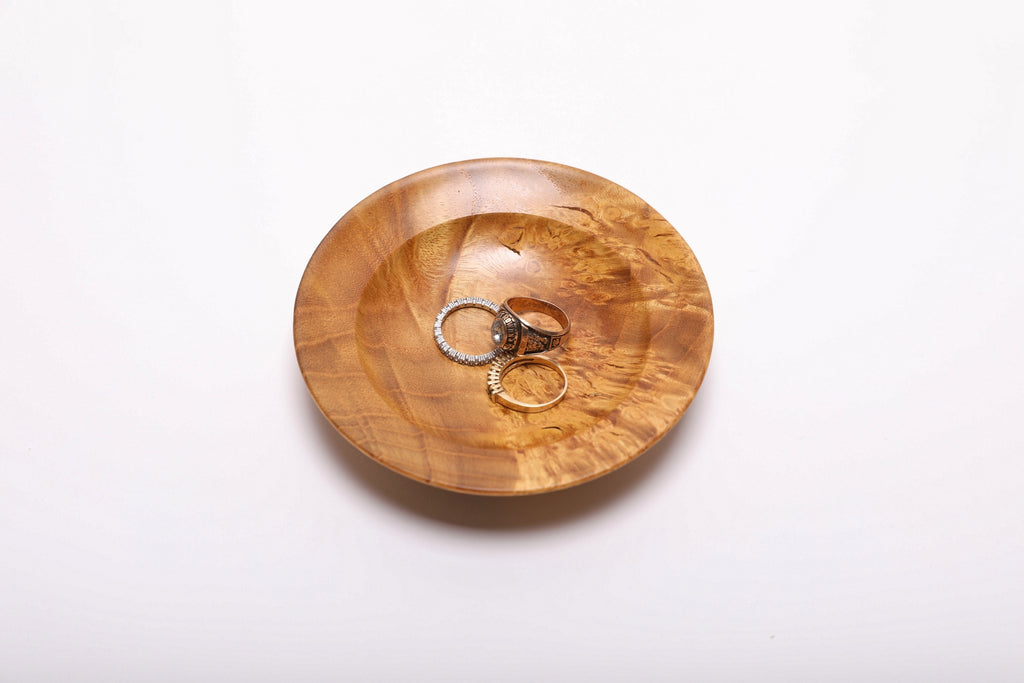 Mulberry burl wood ring dish with three rings showing scale, 4 5/8 inches wide by 1 inch deep, handmade in NC USA