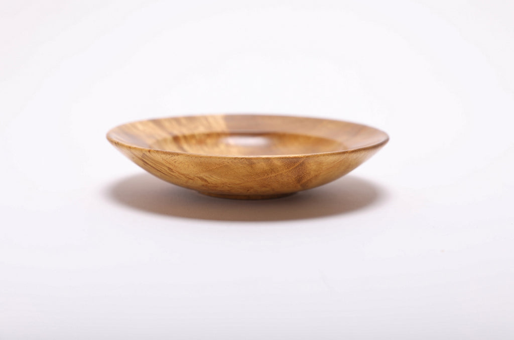 Side view of mulberry burl wood ring dish showing exterior burl figure and graceful low-profile silhouette