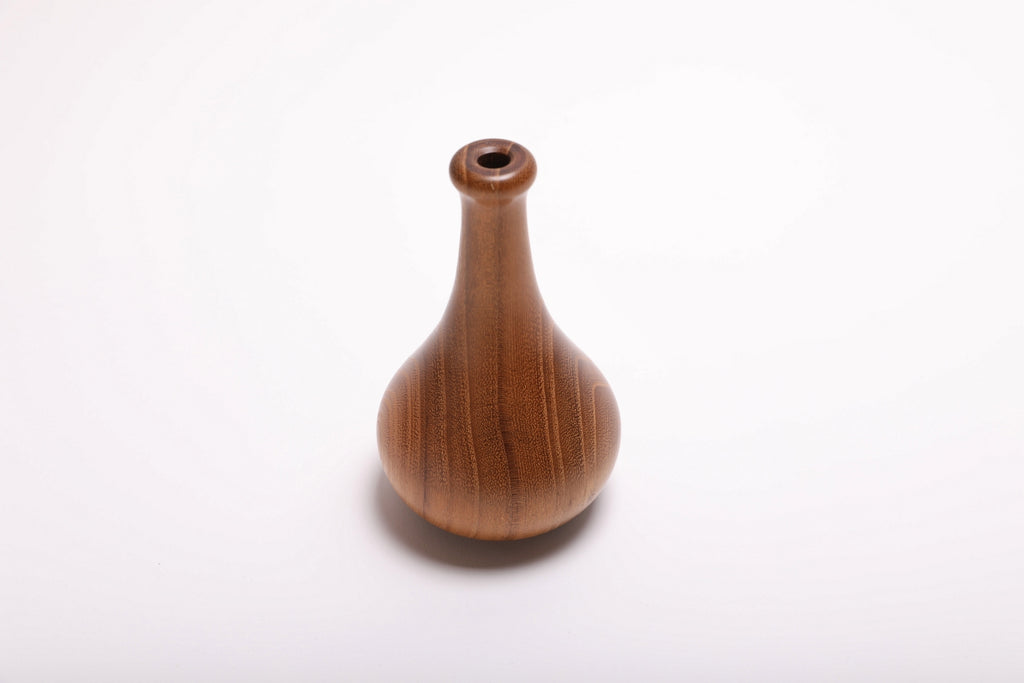 Side view of hand-turned black locust dry vase rotated 90 degrees revealing growth ring pattern and elegant tapered form