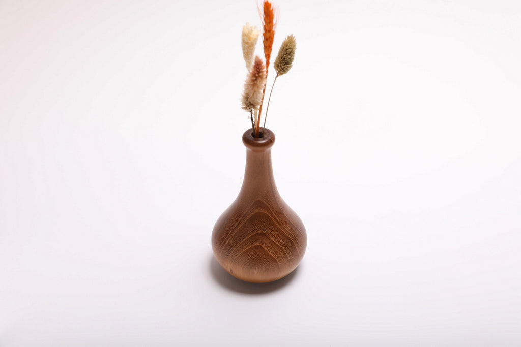 Hand-turned black locust dry vase with dried flowers rotated 90 degrees showing arrangement depth and vase profile