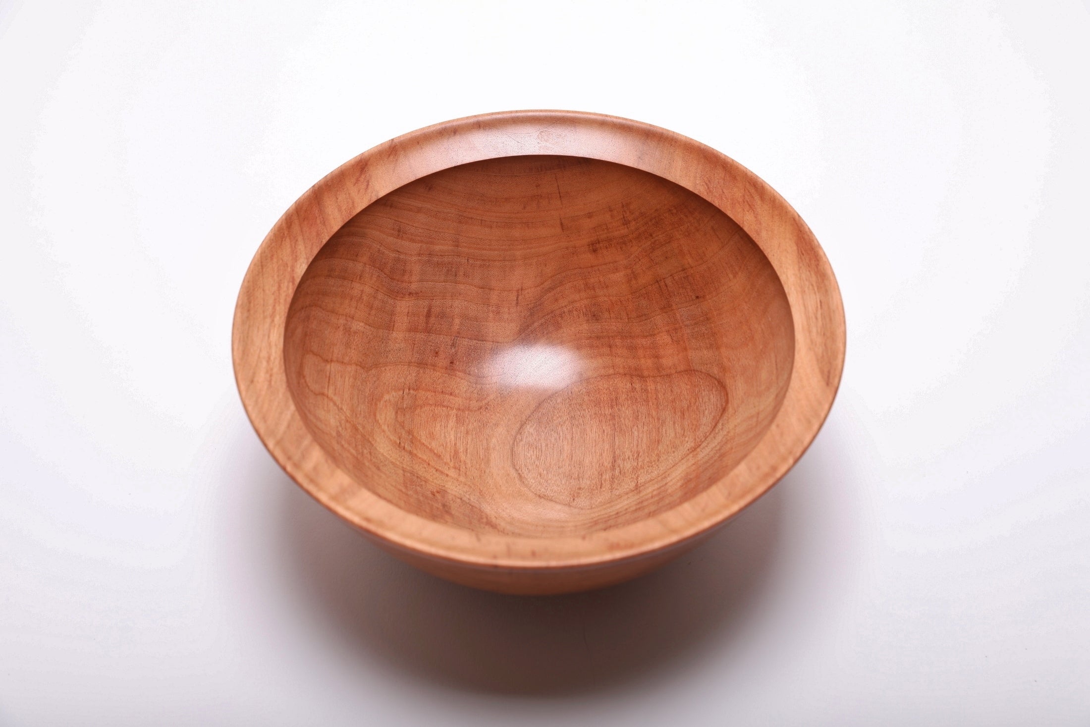 Top view of river birch wooden bowl rotated 90 degrees revealing amber highlights and smooth silky interior surface
