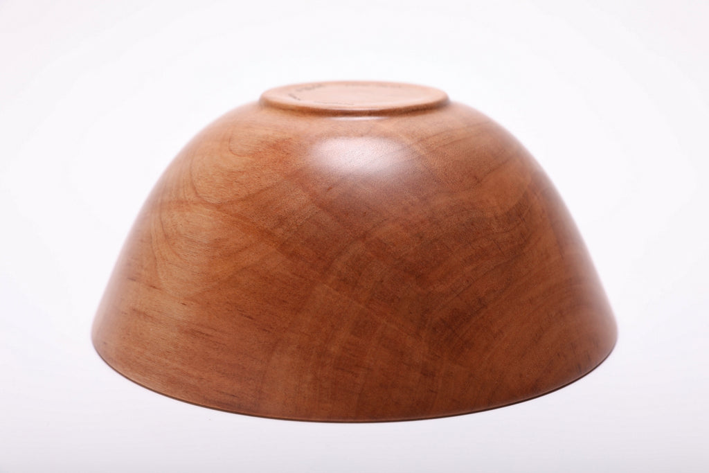 Bottom view of hand-turned river birch wood bowl showing raised foot and natural oil finish on base