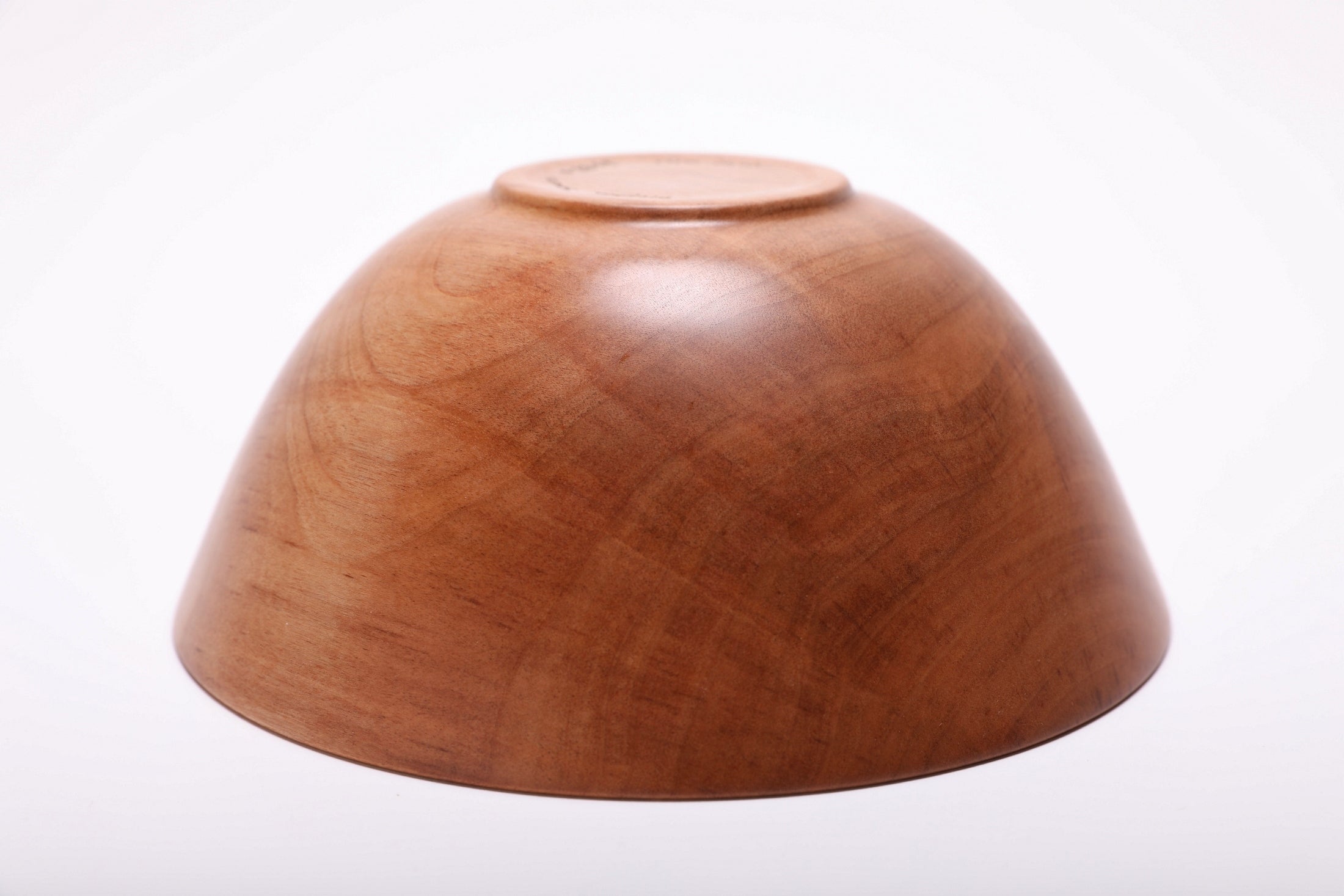 Bottom view of hand-turned river birch wood bowl showing raised foot and natural oil finish on base