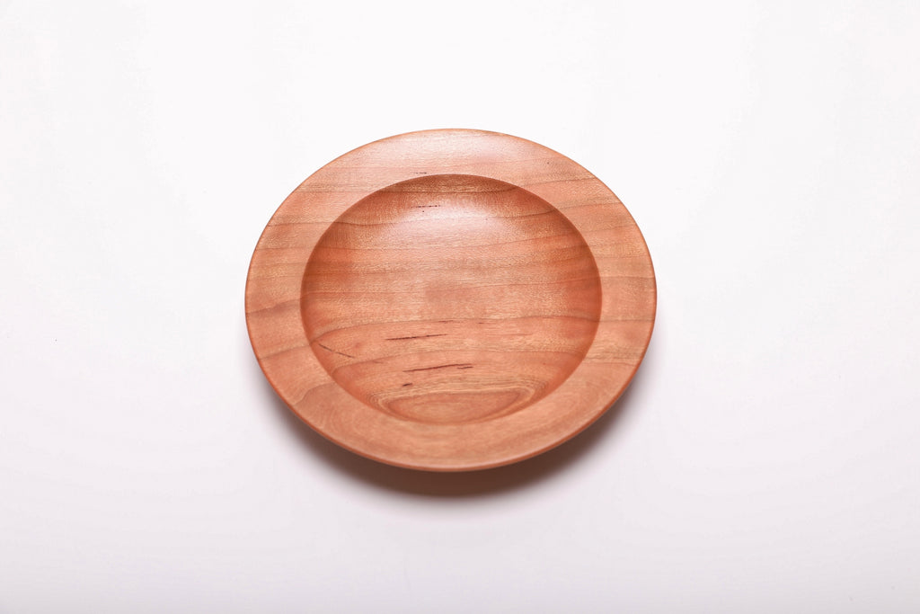 Quartersawn wild black cherry wood ring dish top view showing warm pink and copper tones with straight growth rings, hand-turned, 5 3/8 inches diameter