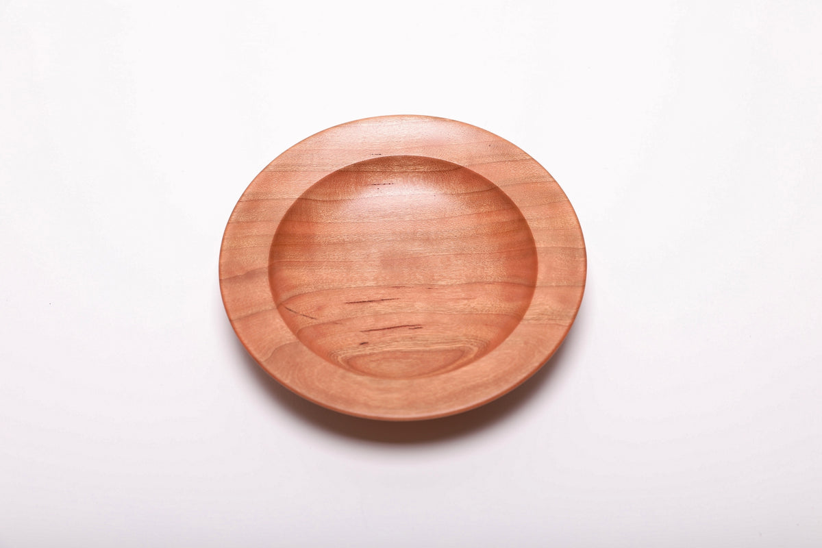 Quartersawn wild black cherry wood ring dish top view showing warm pink and copper tones with straight growth rings, hand-turned, 5 3/8 inches diameter
