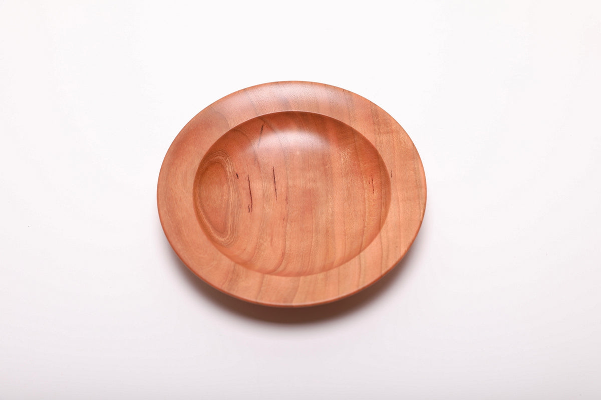 Top view of quartersawn wild black cherry jewelry dish rotated 90 degrees revealing amber-outlined growth ring lines and smooth interior