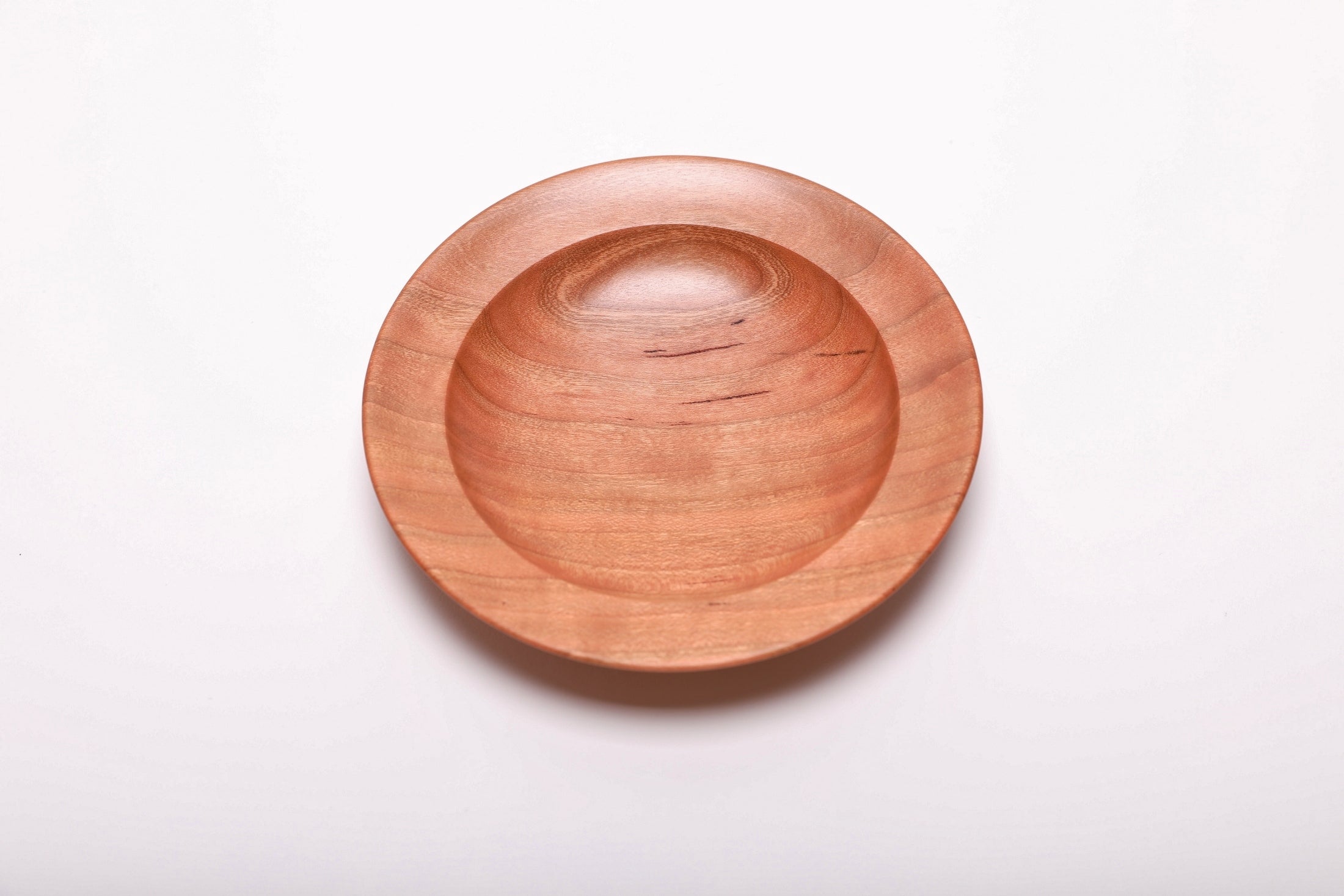 Overhead view of hand-turned wild black cherry ring dish rotated 180 degrees showing full quartersawn grain pattern and lush pink coloration