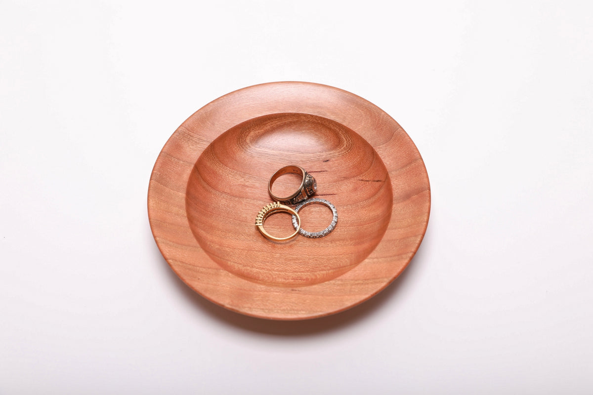 Quartersawn wild black cherry ring dish top view with three rings for scale, showing dish size at 5 3/8 inches wide by 1 inch deep