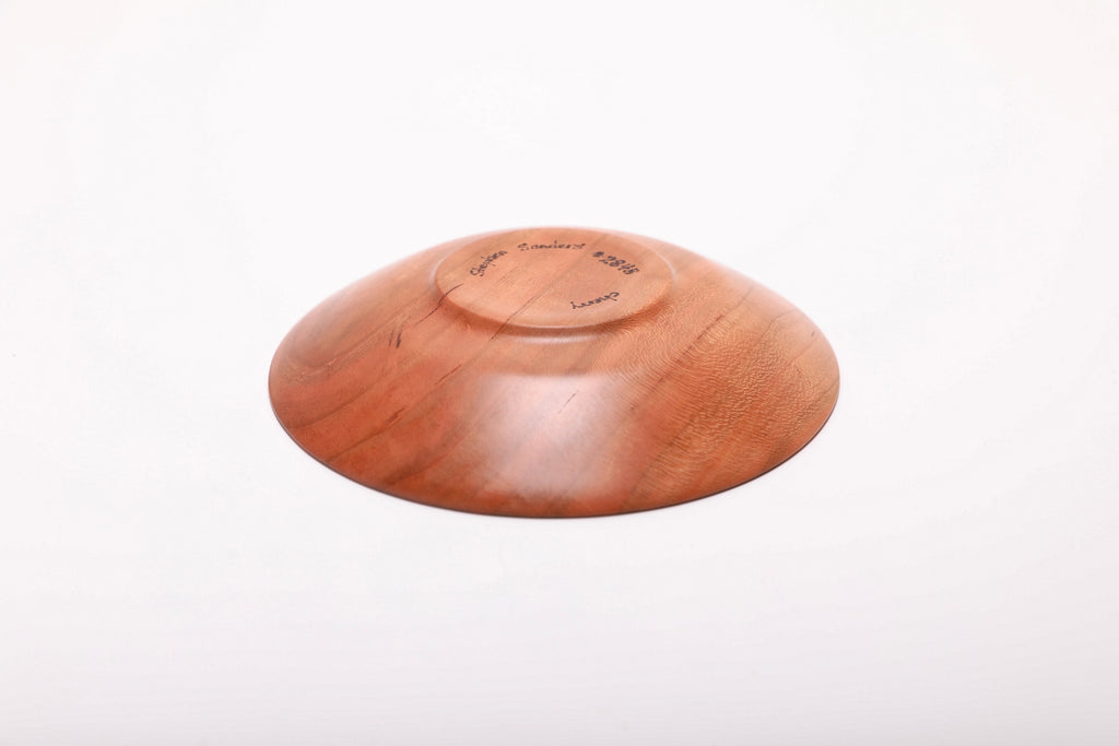 Bottom view of hand-turned quartersawn wild black cherry ring dish showing raised foot and natural oil finish on base