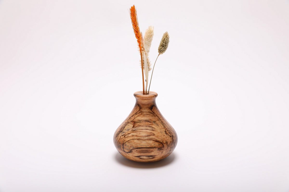 Spalted hackberry wood weed pot with dried flowers, front view showing ink-black spalting lines and gray and amber splotches, 4 1/4 inches tall