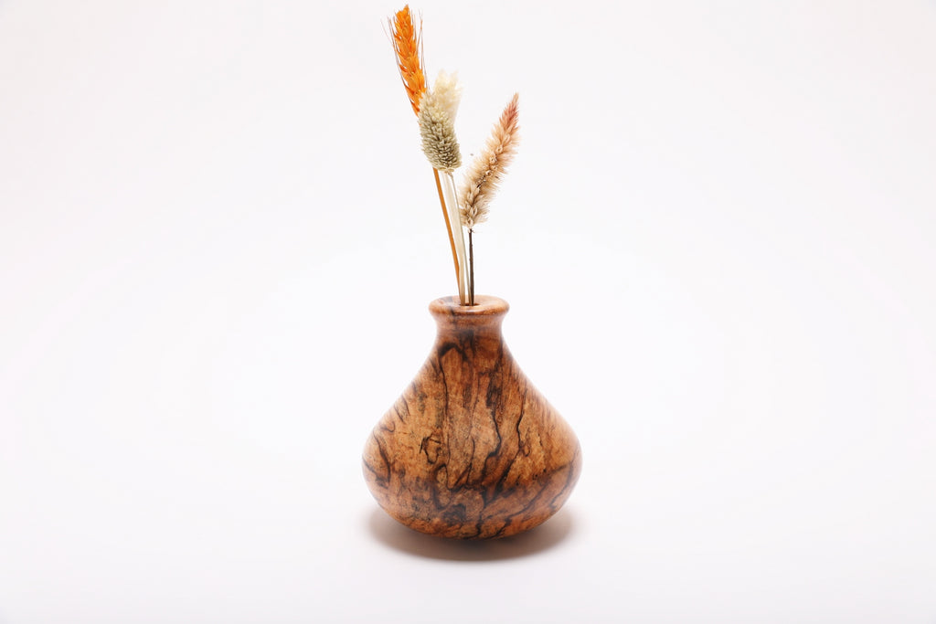 Spalted hackberry dry vase with dried flowers rotated 90 degrees revealing full spalting pattern and natural dried botanical arrangement