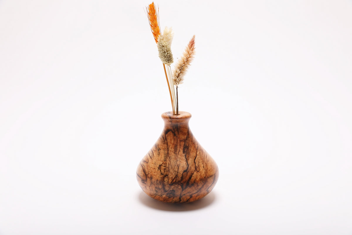 Spalted hackberry dry vase with dried flowers rotated 90 degrees revealing full spalting pattern and natural dried botanical arrangement