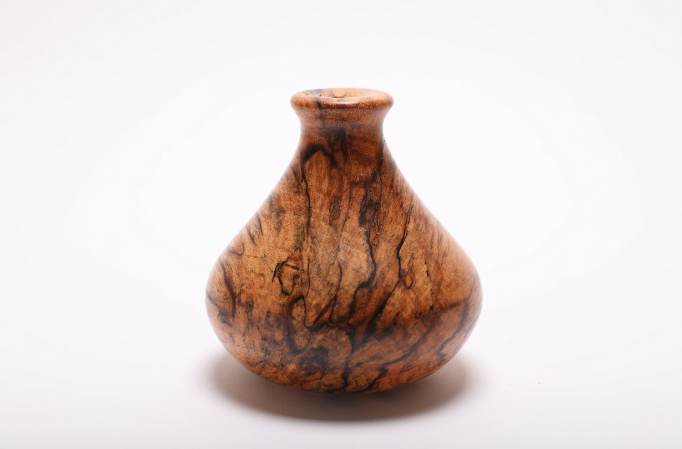 Side profile of hand-turned spalted hackberry dry vase rotated 90 degrees revealing full spalting figure and elegant silhouette