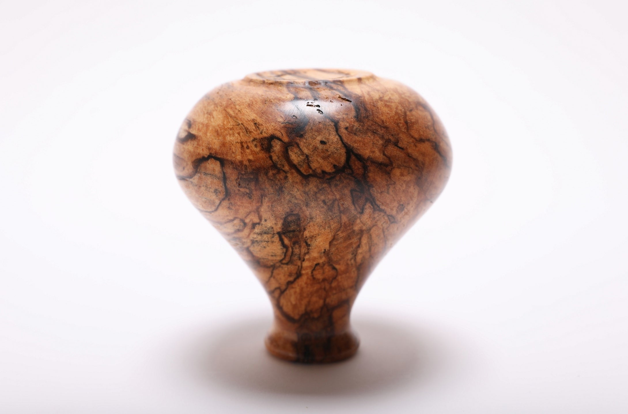 Bottom view of hand-turned spalted hackberry weed pot showing turned base and natural oil finish
