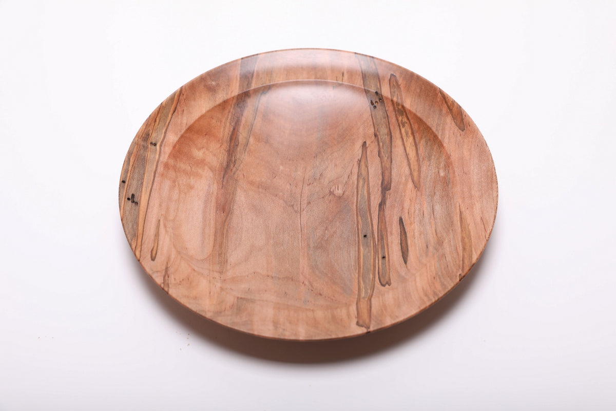 Top view of ambrosia maple shallow dish rotated 90 degrees revealing beetle gallery marks and warm maple tones across the interior