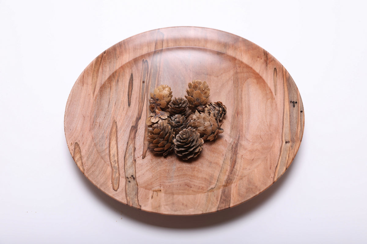 Ambrosia maple shallow wood dish with mini pine cones for scale, showing dish size and shallow depth at 9 inches wide by 1 1/8 inches tall