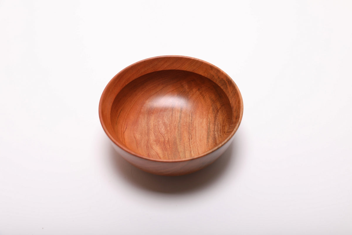 Hand-turned wild black cherry wood bowl, top view with curved undercut rim and rich wood grain