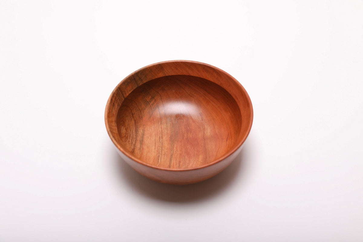 Wild black cherry wood bowl top view, food-safe oil finish highlighting warm grain tones