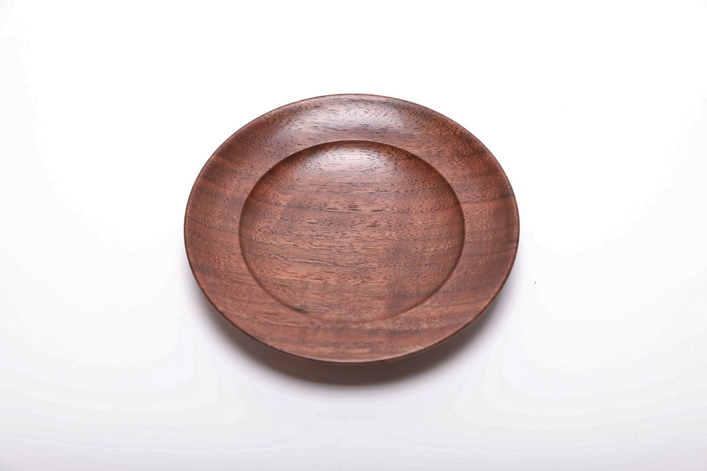 Top view of hand-turned quartersawn black walnut ring dish showing warm reddish-brown grain and curved taper rim, 5 7/8 inches
