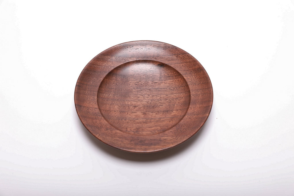 Top view of handmade black walnut ring dish showing dark growth ring transition lines and reddish-brown wood highlights