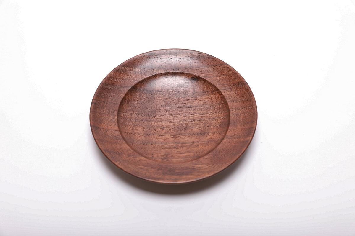 Top view of handmade black walnut ring dish showing dark growth ring transition lines and reddish-brown wood highlights
