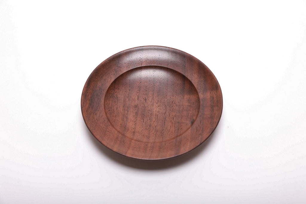Top view of hand-turned black walnut ring dish with raised foot, oil finish, quartersawn walnut grain