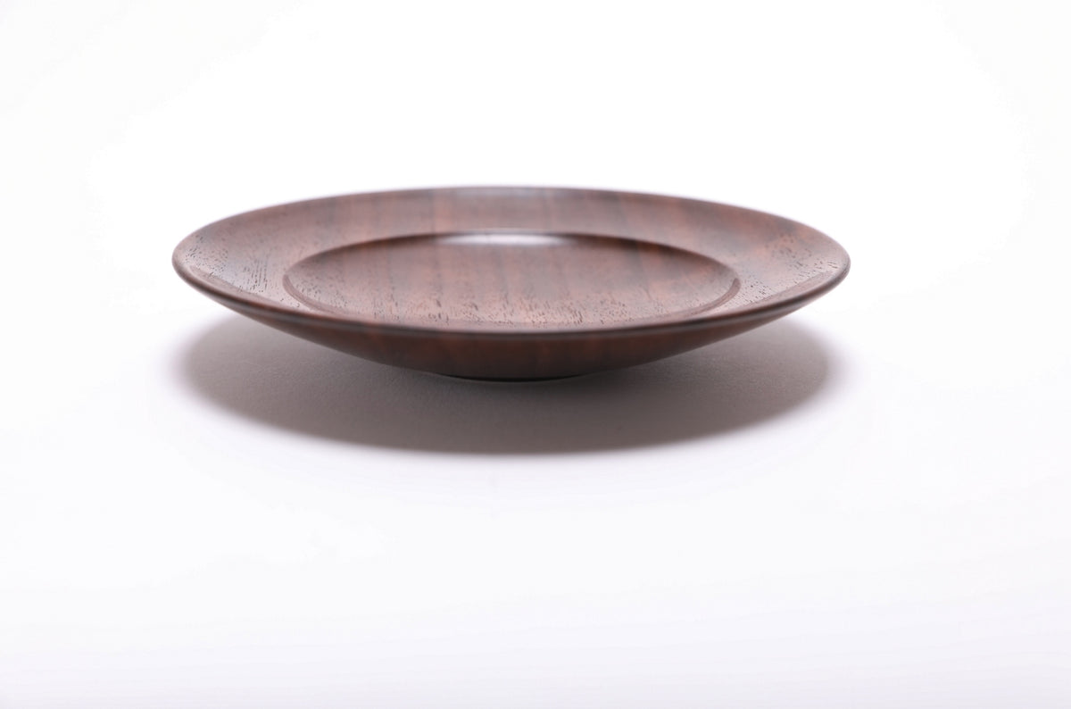 Side view of handmade black walnut ring dish showing curved taper and smooth oil finish, quartersawn walnut