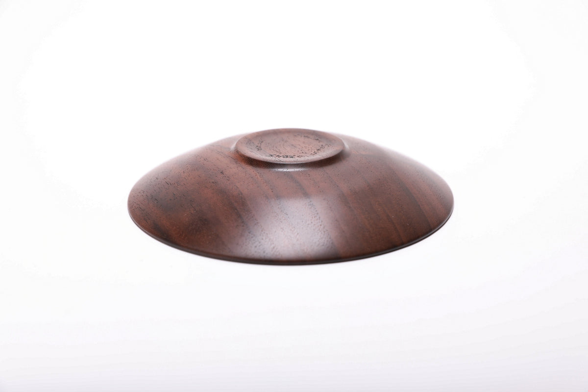 Bottom view of handmade quartersawn black walnut ring dish showing raised foot and natural oil finish