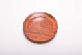 Top view of hand-turned wild black cherry burl ring dish showing warm pink-orange grain with swirling burl figure, 5 3/8 inches