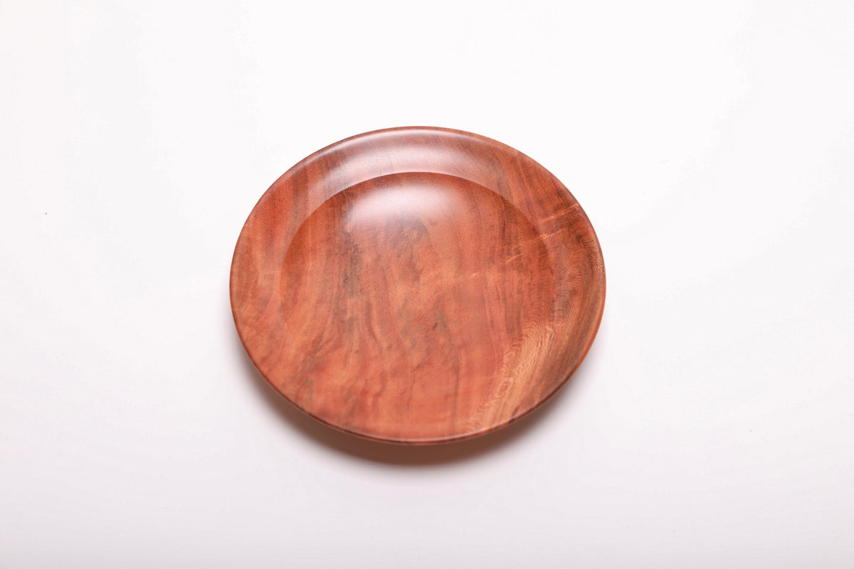 Top view of wild black cherry burl ring dish highlighting deep pink-orange coloration and curved taper undercut rim