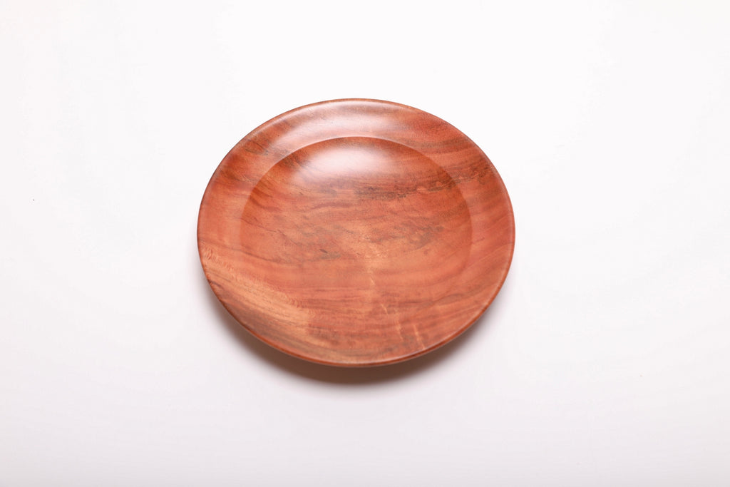 Top view of handmade black cherry burl ring dish showing brown highlights and natural burl figure from 200-year-old cherry tree