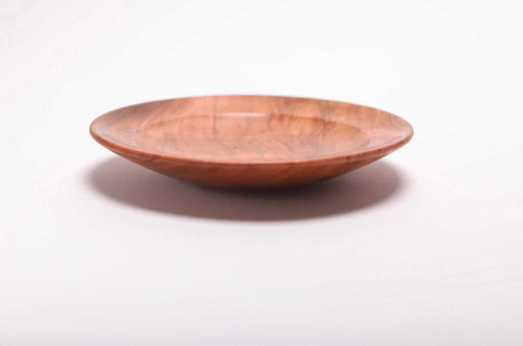 Side view of handmade black cherry burl ring dish highlighting burl figure and smooth natural oil finish