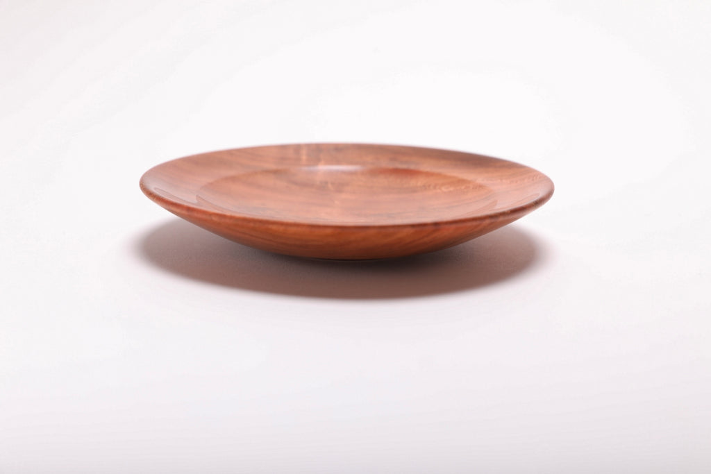 Side view of wild black cherry burl ring dish showing curved rim profile and brown highlights along the edge