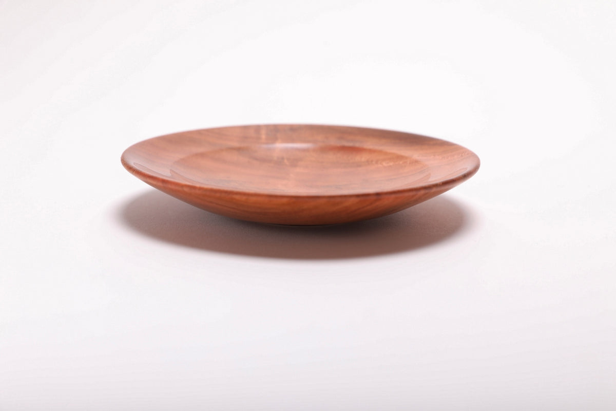 Side view of wild black cherry burl ring dish showing curved rim profile and brown highlights along the edge