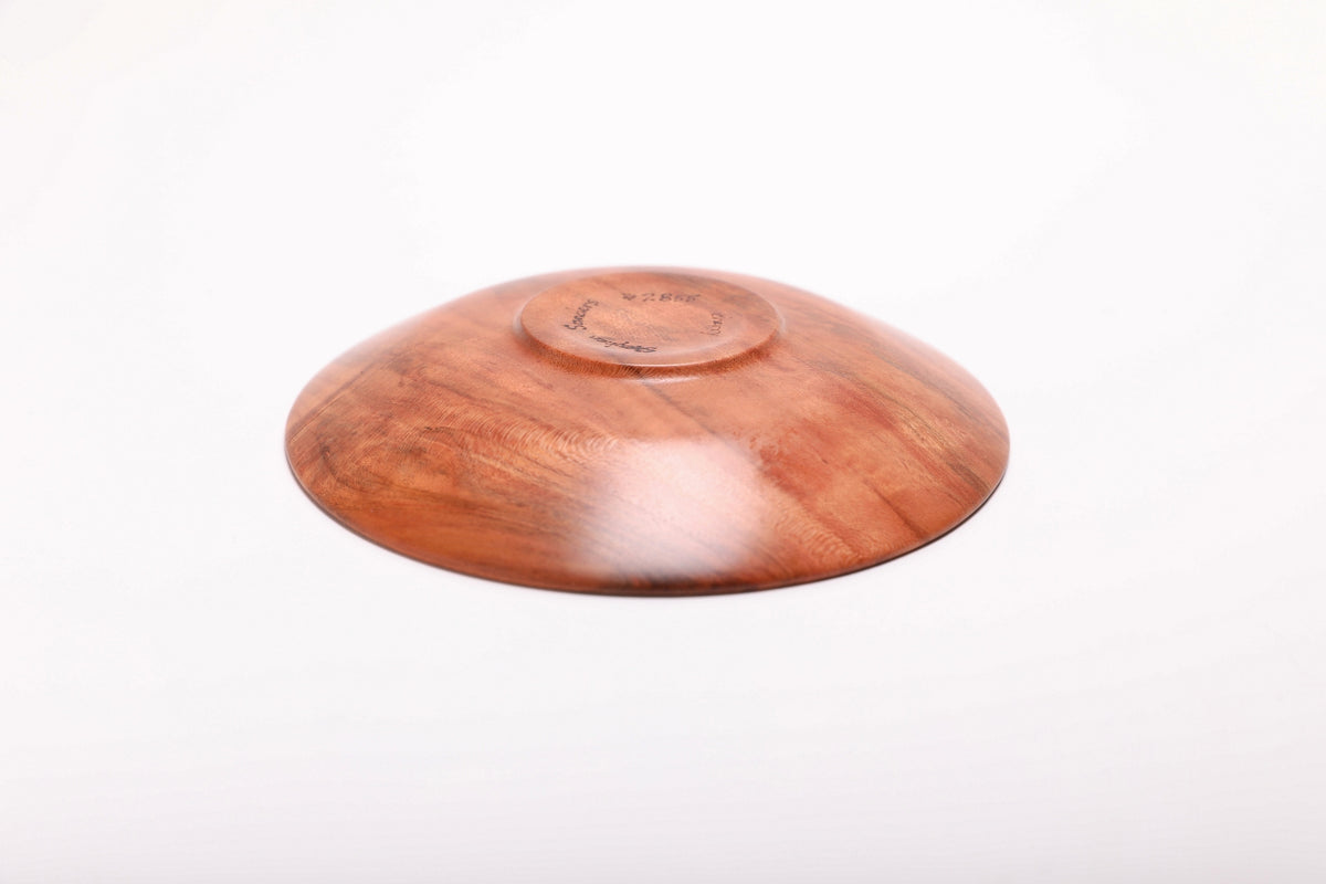 Bottom view of handmade wild black cherry burl ring dish showing raised foot and natural oil finish
