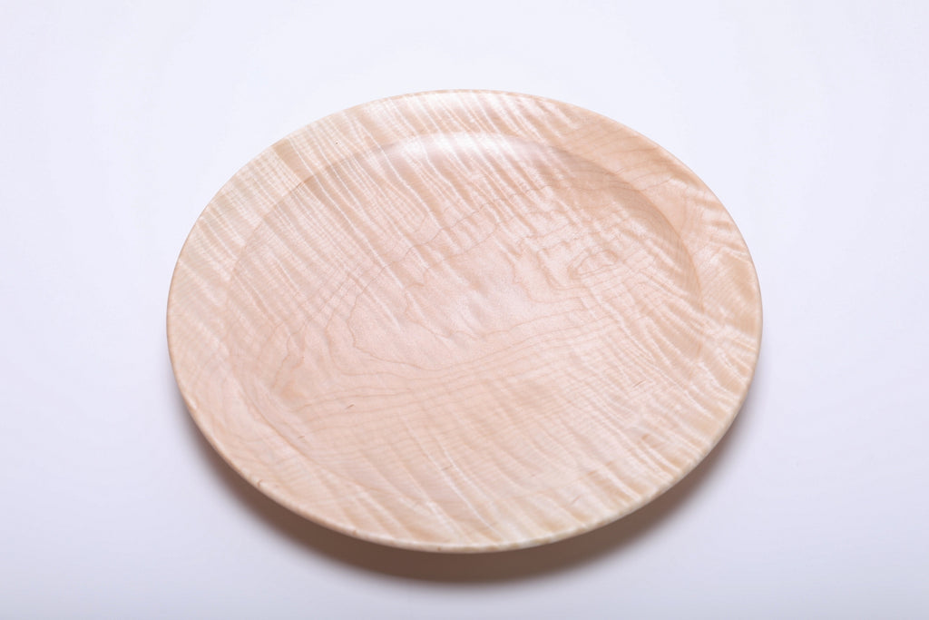 Top view of hand-turned tiger maple platter showing full grain pattern with curly figure and undercut rim