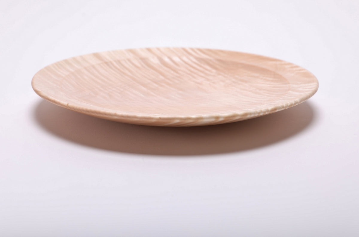 Side profile of hand-turned tiger maple wooden platter showing curved taper, raised foot, and honey-toned grain, 1 1/8 inch height