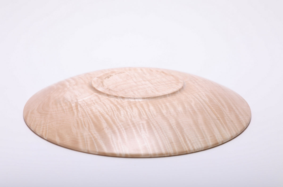 Bottom view of handmade tiger maple wooden platter showing raised foot and natural oil finish