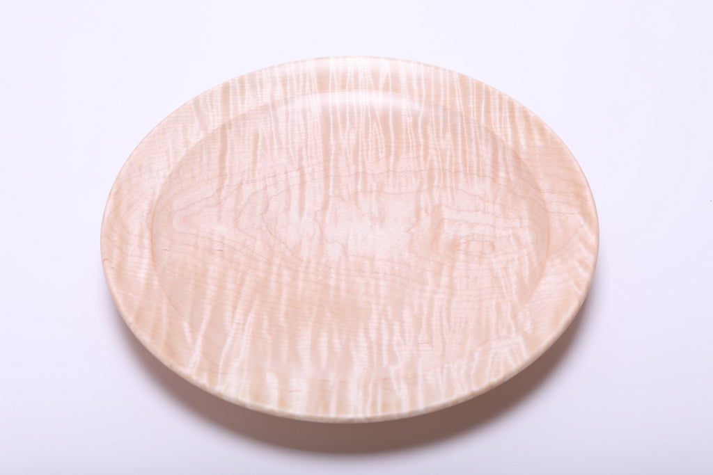 Top view of tiger maple wooden platter highlighting warm honey tones and chatoyant shimmer across the surface