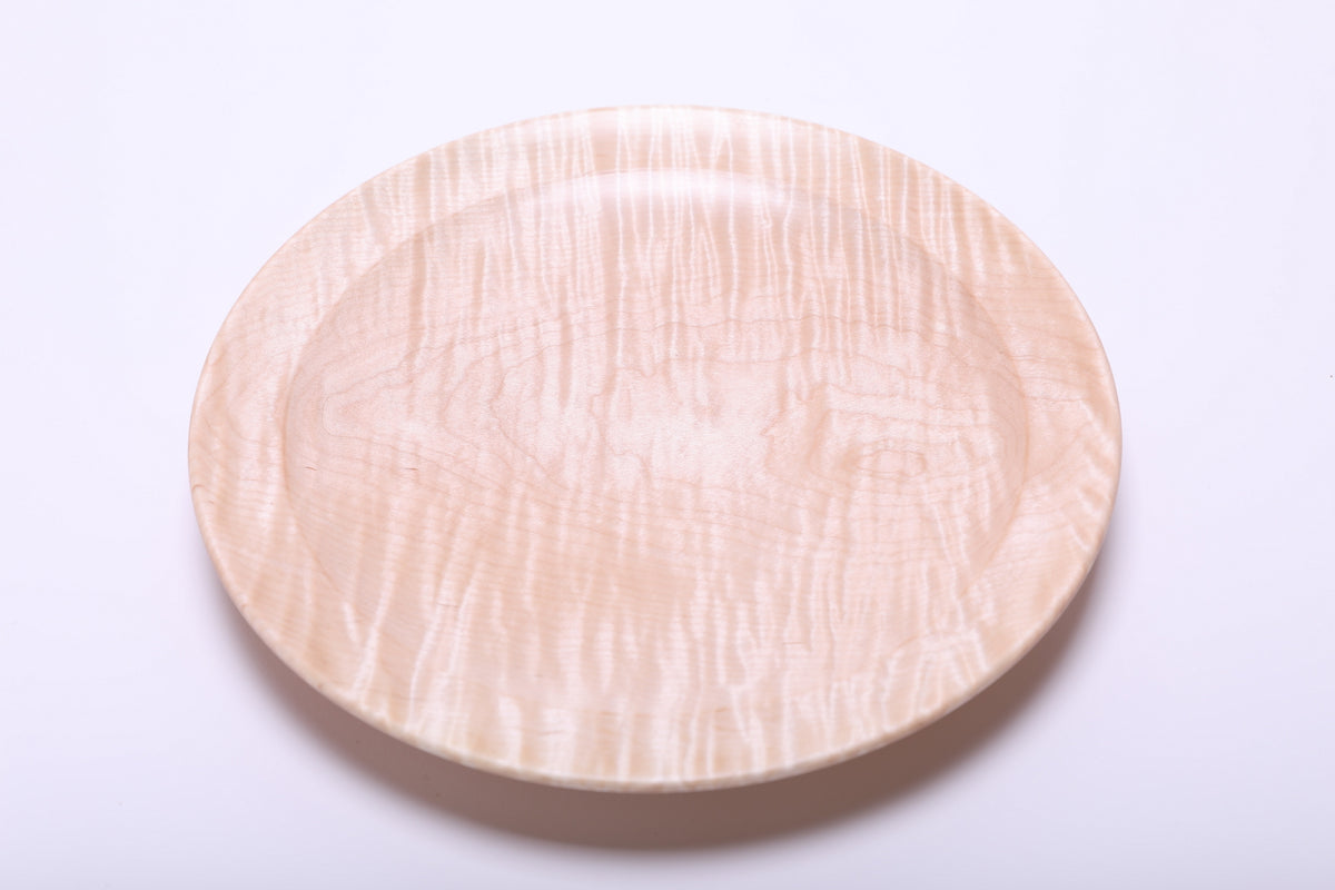 Top view of tiger maple wooden platter highlighting warm honey tones and chatoyant shimmer across the surface