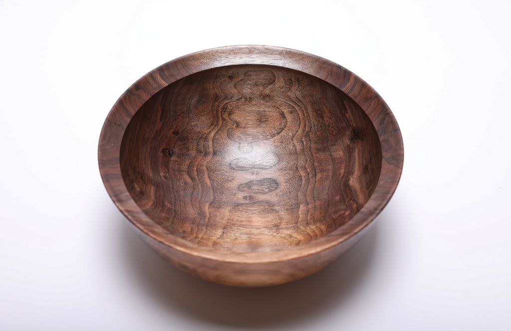 Top view of hand-turned spalted wild black walnut bowl showing snowman figure and rich brown grain with undercut rim, 9 3/8 inches