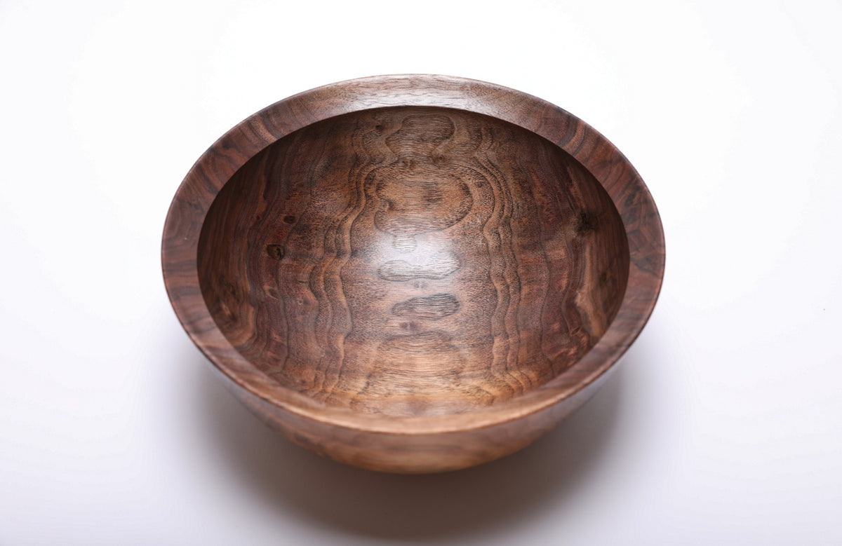 Top view of hand-turned spalted wild black walnut bowl showing snowman figure and rich brown grain with undercut rim, 9 3/8 inches