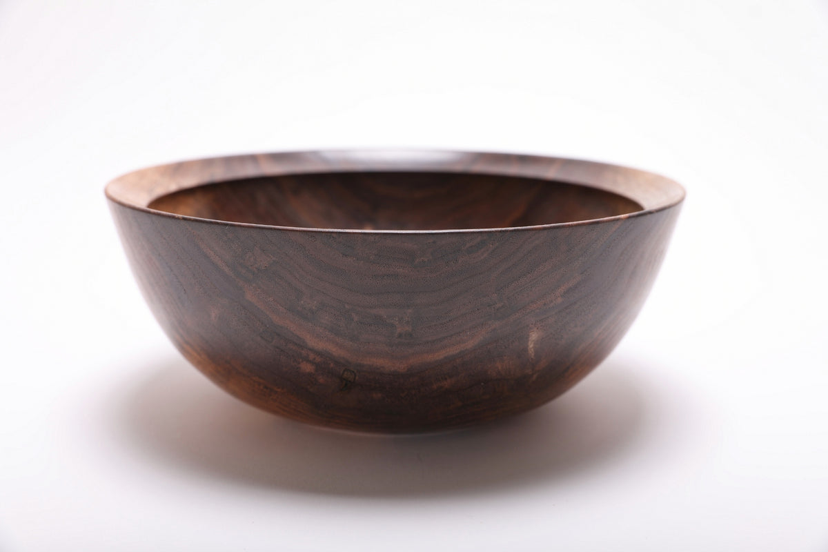 Side view of handmade spalted black walnut bowl highlighting spalted sapwood figure and smooth natural oil finish