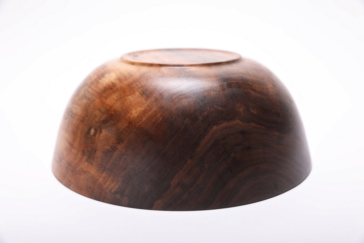 Bottom view of handmade spalted wild black walnut bowl showing raised foot and natural oil finish